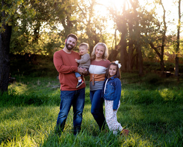 Fall family portrait standing in pasture