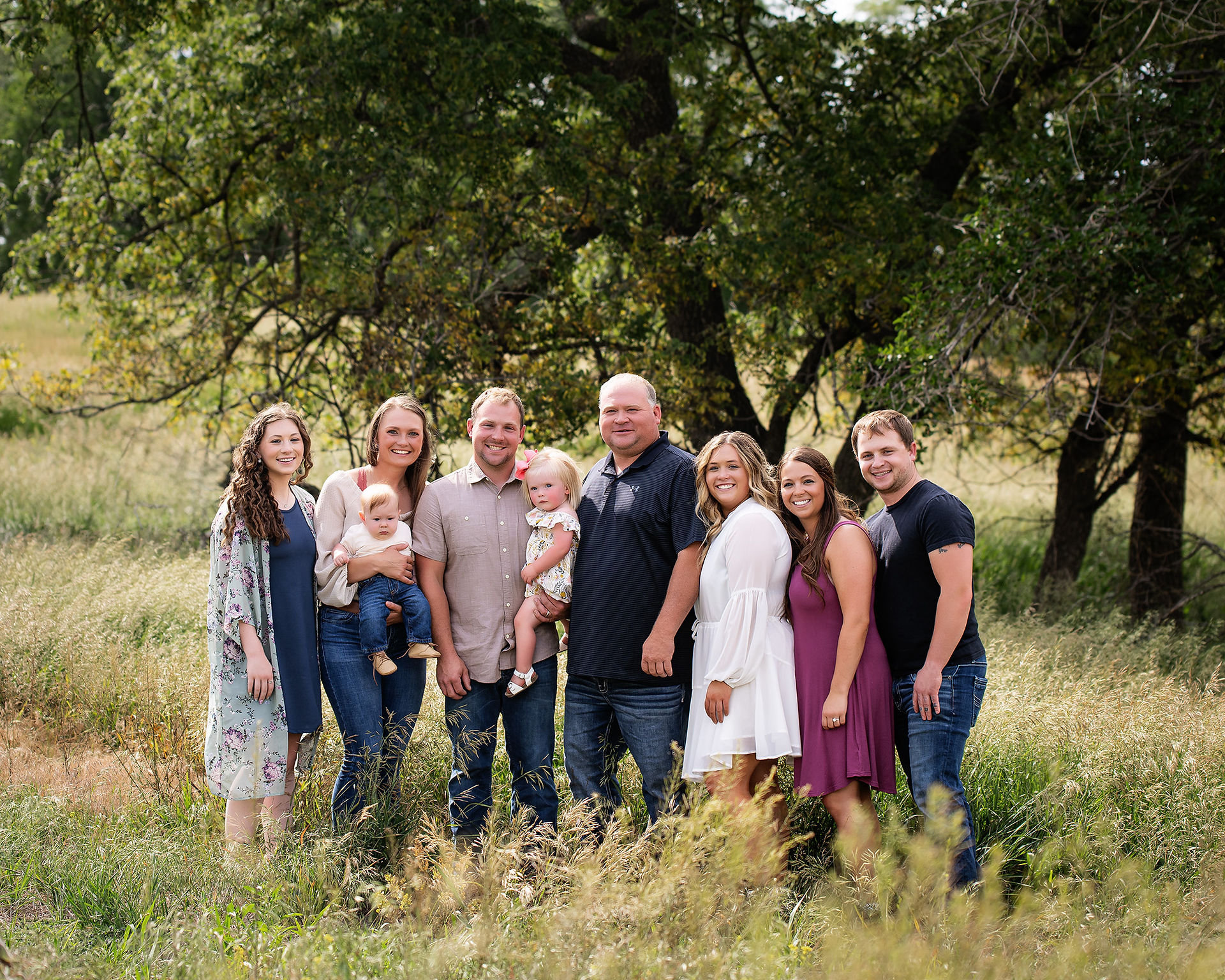 Family members standing side by side for an extended family event.