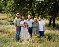 Family members standing side by side for an extended family event.