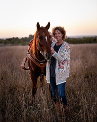 Lady with her horse in field