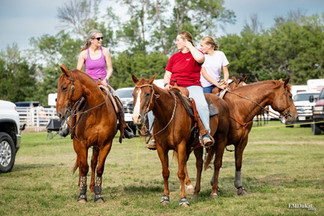 A group of ladies on horseback chat while waiting for the start of the Cass County Fair barrel race in Weeping Water, Nebraska. 