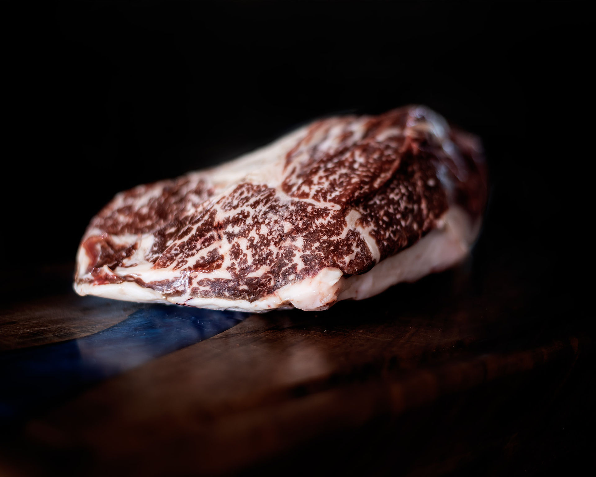 Wagyu steak on a wooden cutting board from Wackel Farm Wagyu. 