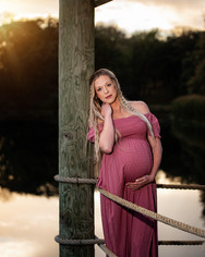 Pregnant woman downed in pink standing on dock at Platte River State Park 