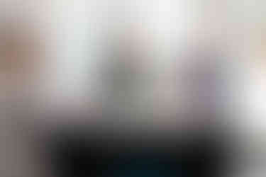 Alluring Events & Design ladies stand at their booth during a networking event.