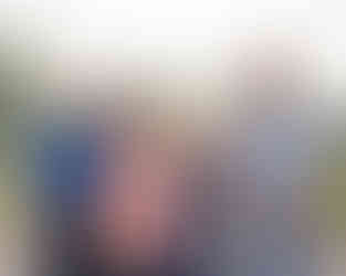 Four family members standing side by side for an extended family event.