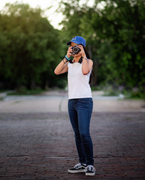 Senior female with camera on brick road