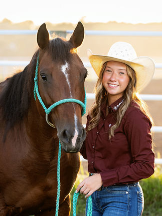 Senior girl poses for portraits with her horse.
