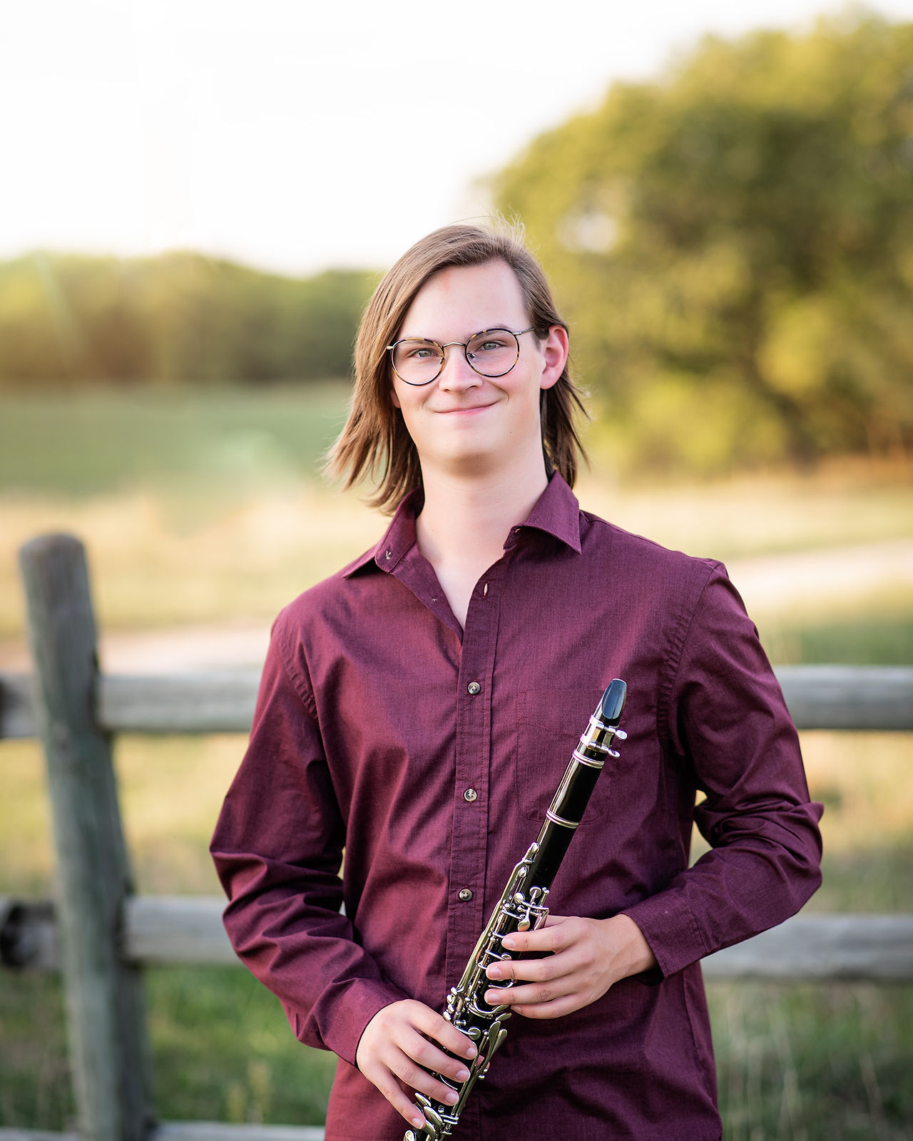 Senior boy posing with his clarinet at Mahoney State Park in Nebraska. 