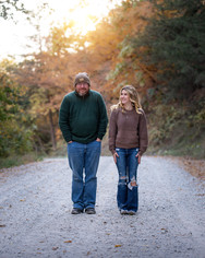 Couple standing on dirt road on chilly day 
