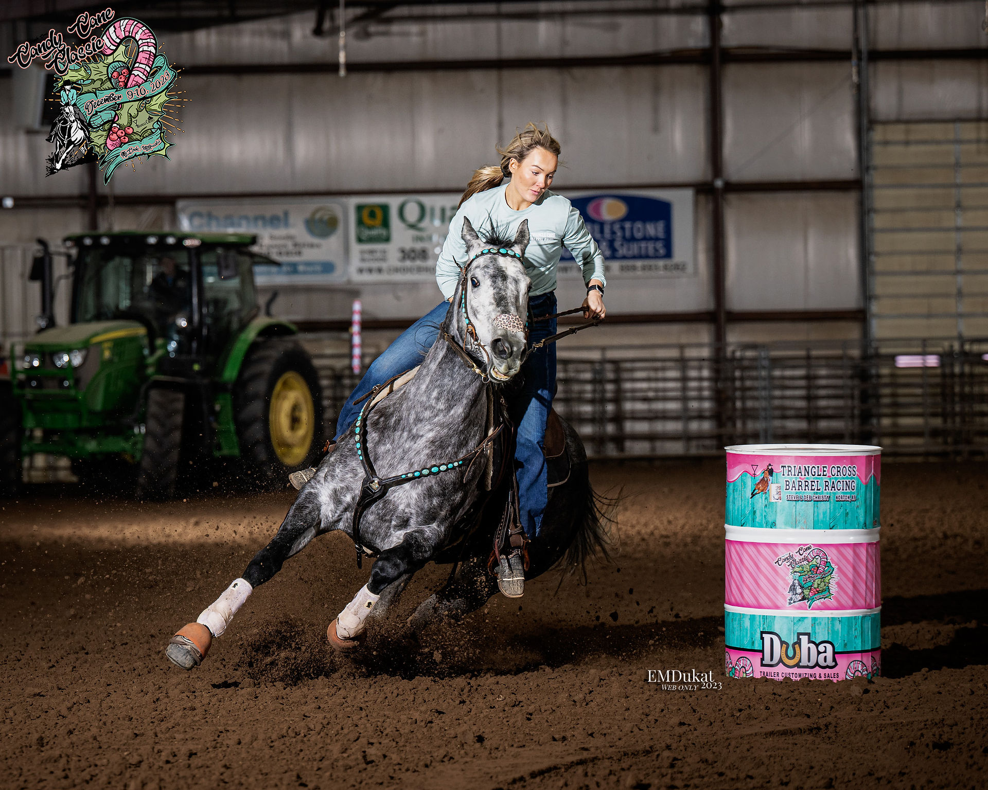 Cowgirl runs her grey horse through the barrel racing pattern during the Candy Cane Classic event at the Kiplinger Arena.