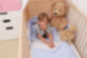 toddler in crib.jpeg