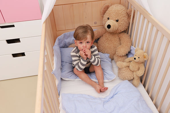 toddler in crib.jpeg
