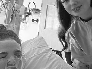 Hannah recovering in hospital bed.