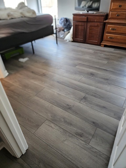 Gray wood-look flooring in a bedroom