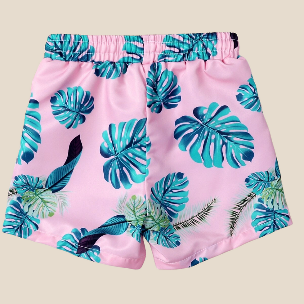 Thumbnail: pink swimming trunks for toddler with green leaves around back view in beige background