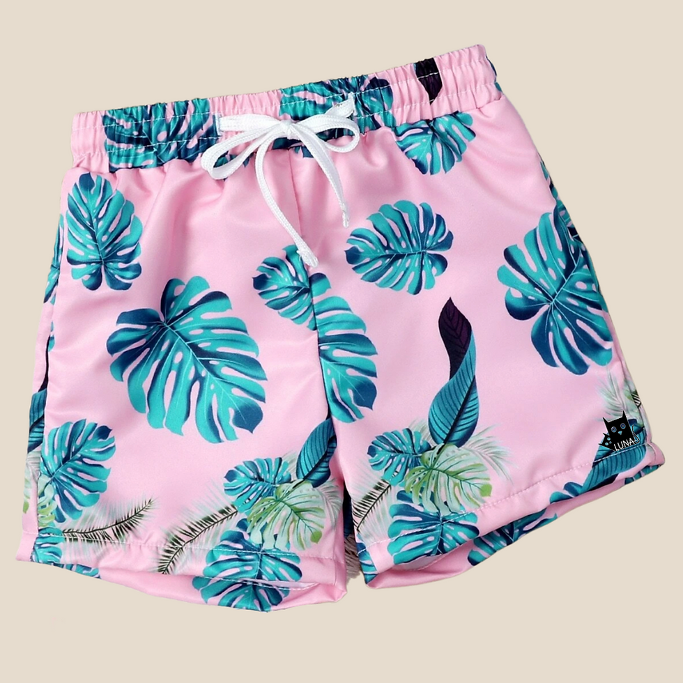 Thumbnail: pink swimming trunks for toddler with green leaves around front view in beige background