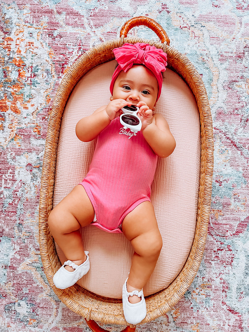 baby girl wearing a hot pink onesie with the words Baby in barbie font