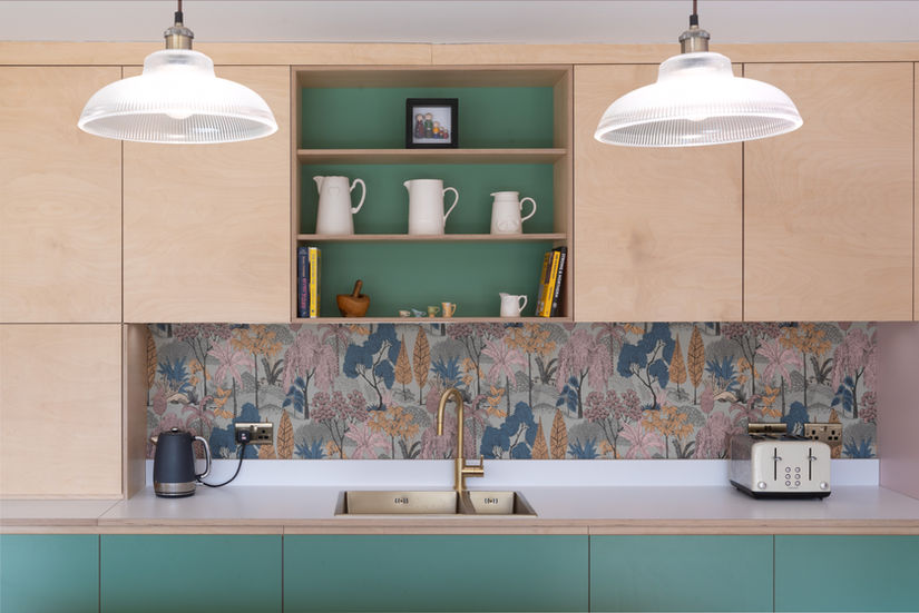 Bespoke plywood kitchen with birch wall units, green base units and floral splashback