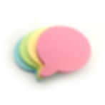 Two stacks of colourful speech bubble-shaped sticky notes featuring the colours pink, yellow , green and blue.