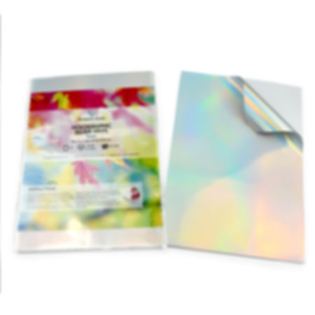 A colorful instructional book, next to a blank A4 Holographic Silver Vinyl sticker.