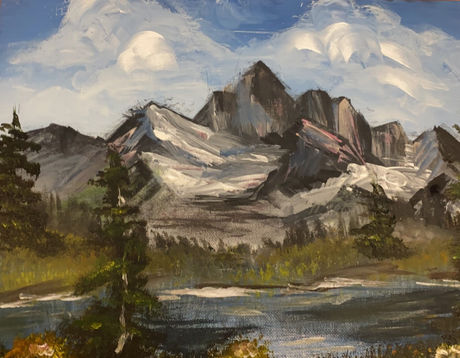 Mountain range with a lake and trees in the foreground