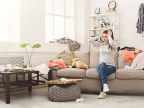 Woman looking frustrated and overwhelmed by clutter