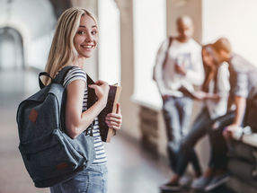 University student holding files university packing checklist