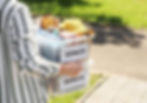 person carrying crates of donated items