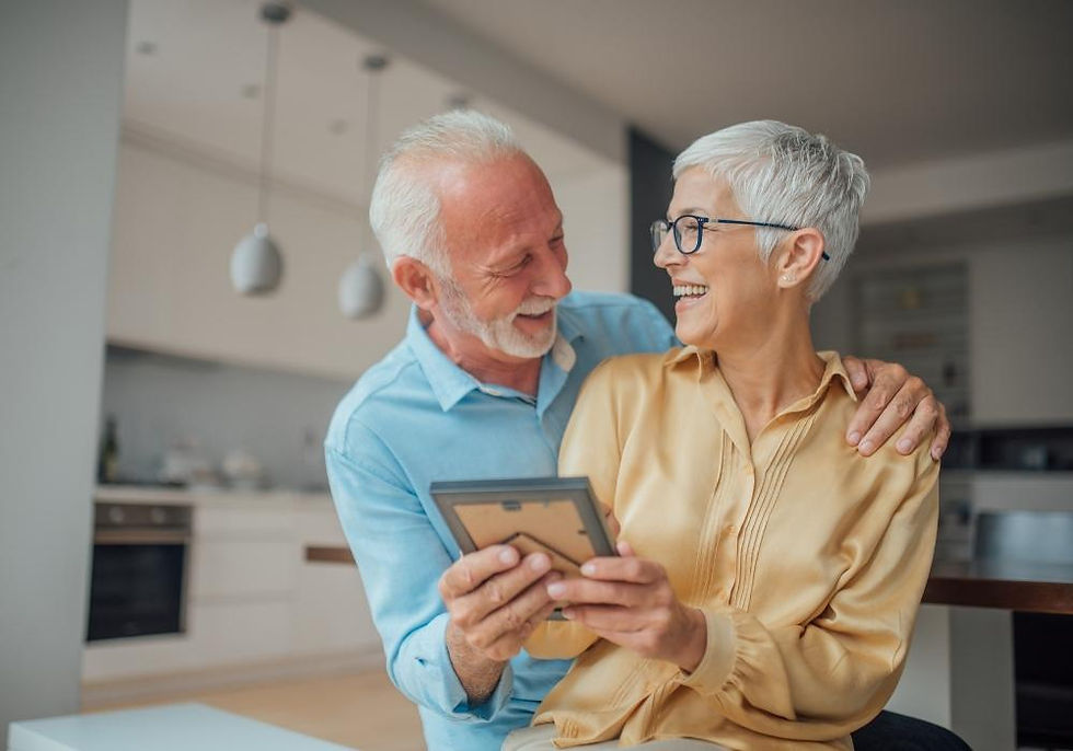 older couple holding a photo they love