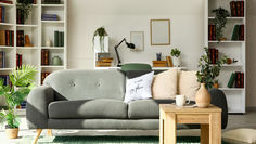 Calm and organised family living room with desk behind sofa