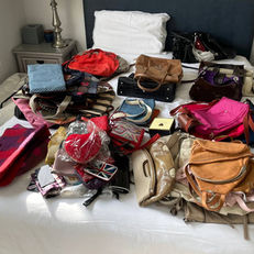 Decluttering by category - handbags gathered on a bed ready to joy check and declutter using the KonMari Method with Master KonMari Consultant Sue Spencer