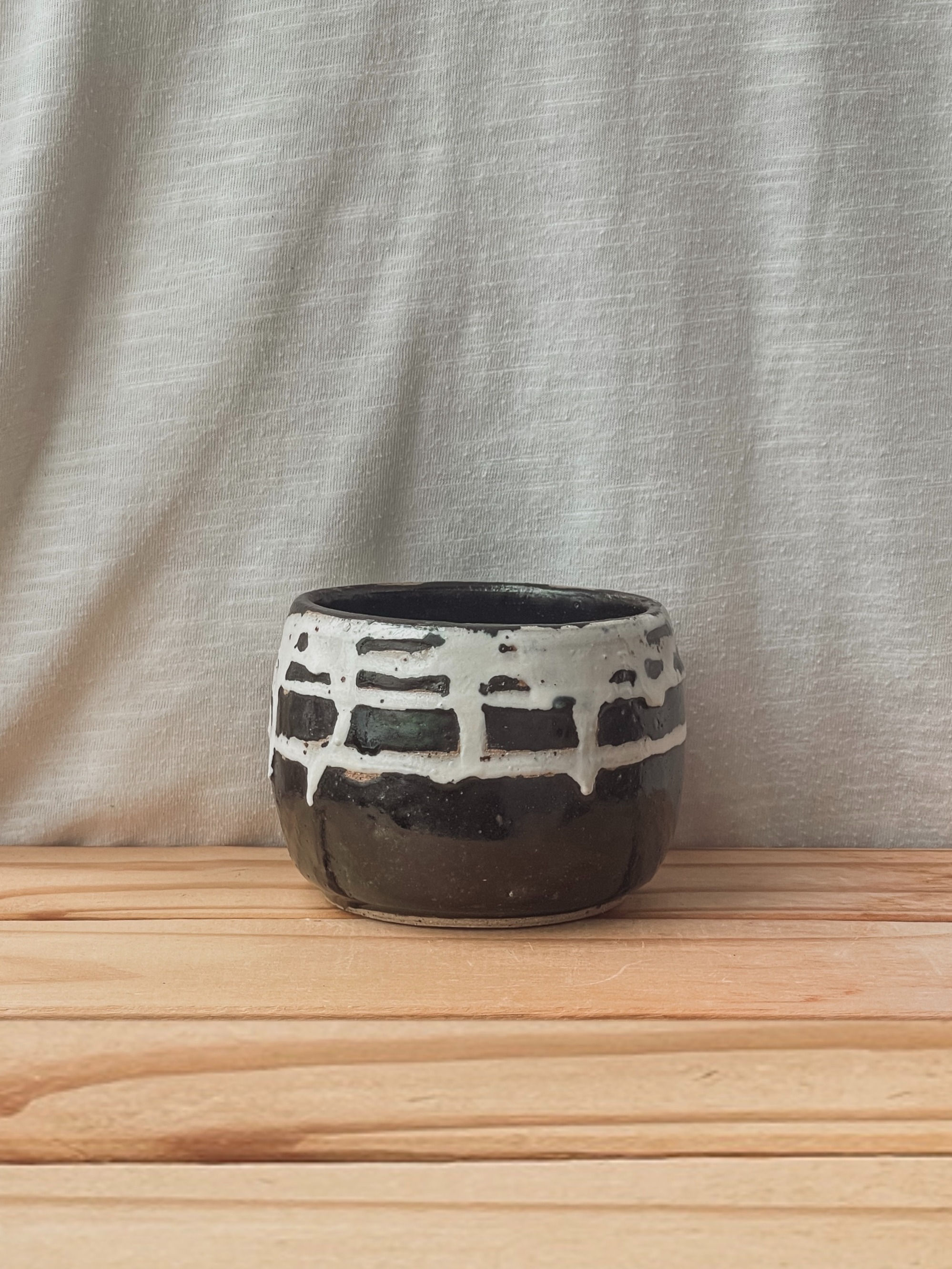 Black slip-decorated vessel