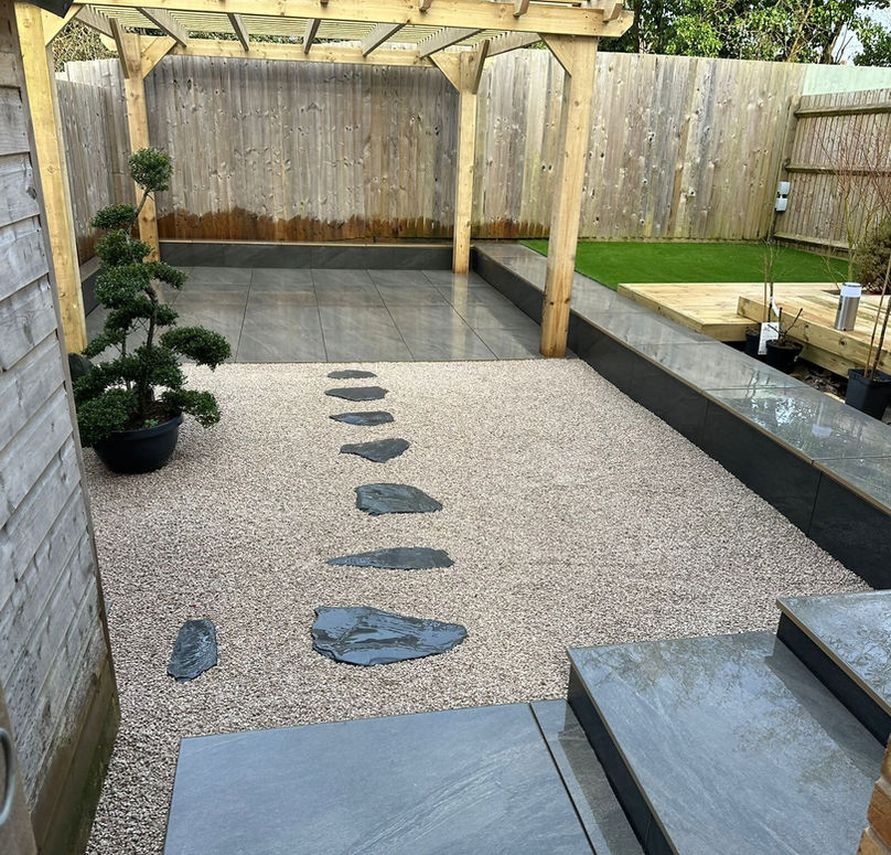 Composite paving and pergola near the fence
