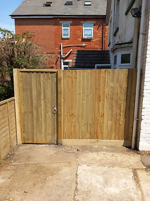 New gate constructed by the side of a building