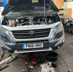 Car bonnet opened and being repaired in the garage