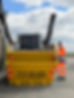 Man in high visibility uniform loading a yellow skip