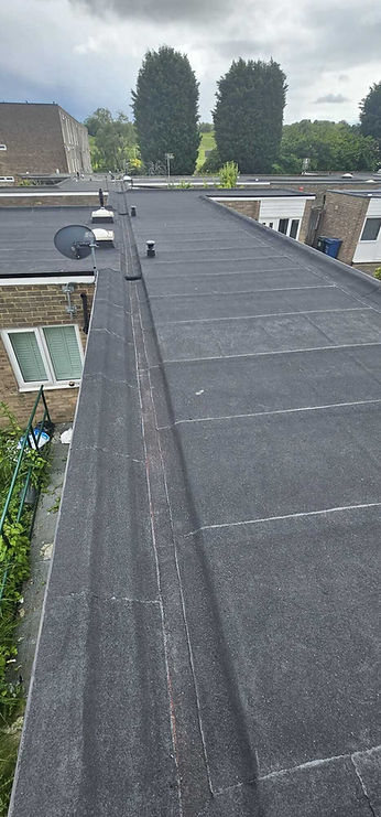 Long flat asphalt roof section installed on residential terrace property