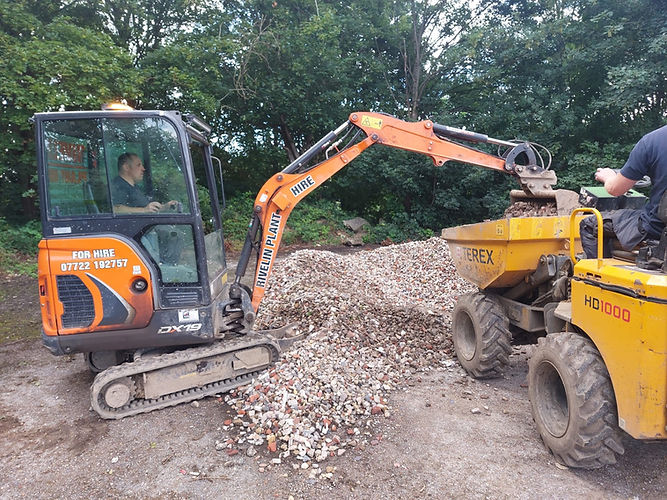 Grab machine operator loading gravel onto dumper truck