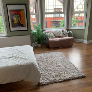 cleaned bedroom with sofa in the window