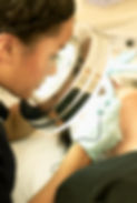 Woman doing electrolysis hair removal on client
