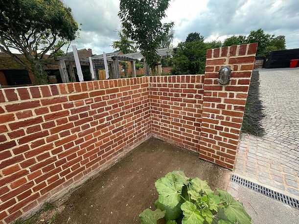 Repointing garden wall by a building