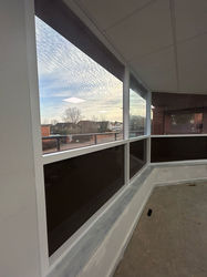 A side angle of the finished white window frames and clean glass panels