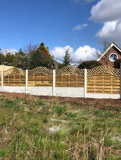Neat row of wooden fence panels running along a domestic garden border
