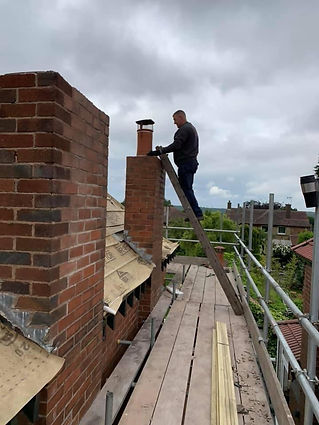 Roofer on the roof working on chimney