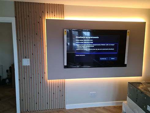 Wall-mounted TV feature with timber slat panelling and LED lighting.