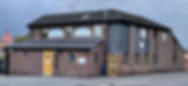 Large brown building with yellow doors