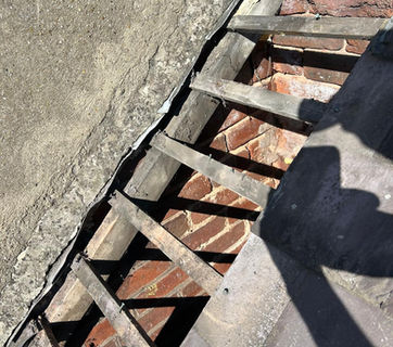 Missing tiles on a roof exposing the wood slats