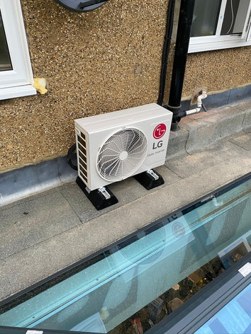 New air conditioning unit by the side of a building