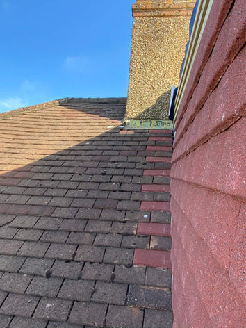 New tile roof by chimney on a building