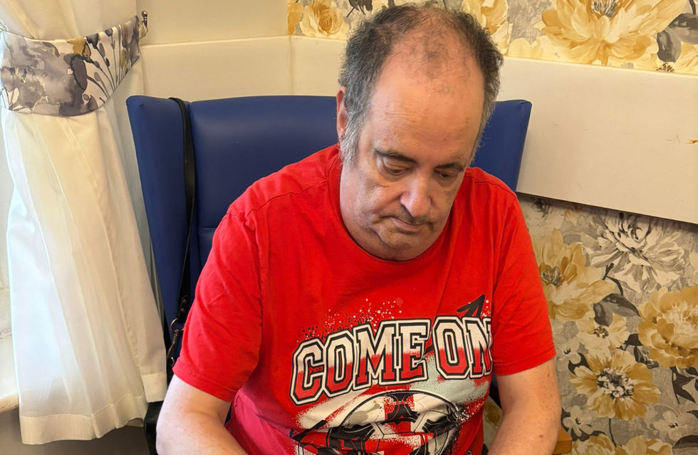 Elderly man doing craft work on a table